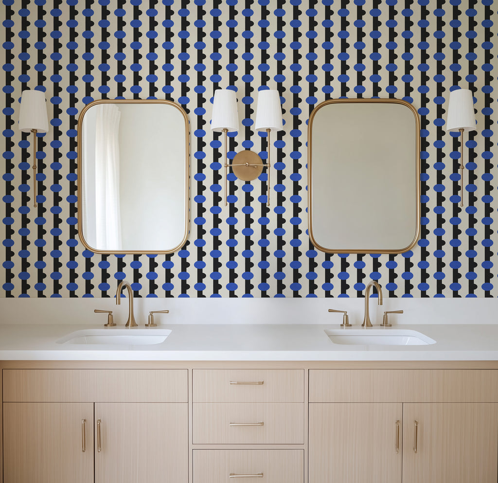 Geometric wallpaper pattern featuring repeating circular motifs set within vertical bands, combining rounded forms and structured lines for a bold, modern design with rhythmic movement. Light wood vanity with white countertops. Ivory, black and blue, art deco, maximalist