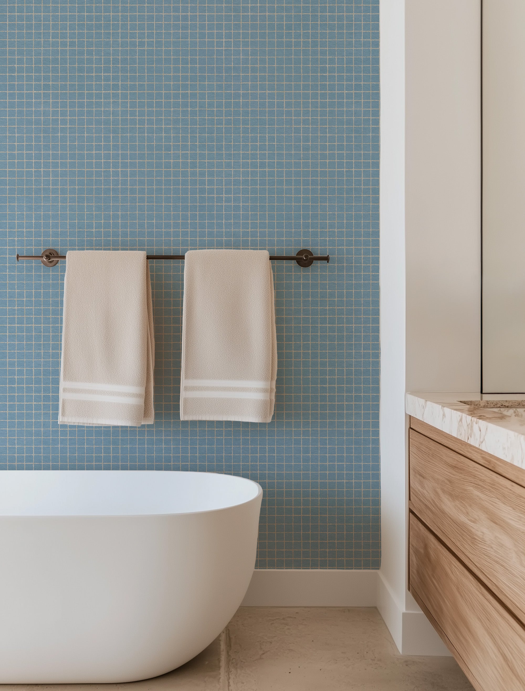 Geometric grid wallpaper pattern with clean, intersecting lines arranged in a structured, modern layout, creating a crisp and graphic design ideal for contemporary interiors. Blue and white check, graphic squares in bathroom with freestanding tub