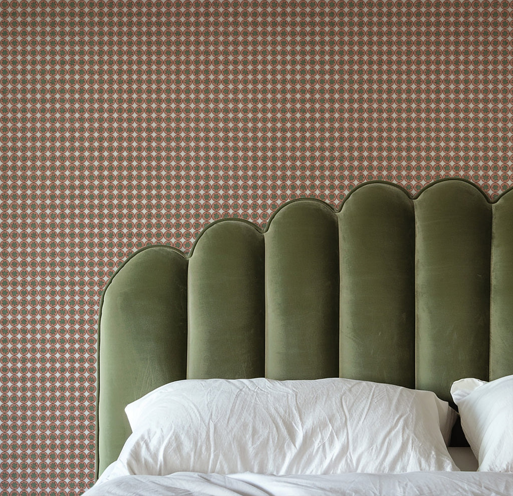 Pattern of small circles in pink and green on a gray background Small-scale geometric wallpaper pattern featuring repeating circular medallions with floral-inspired centers, creating a refined, rhythmic design with classic charm and decorative detail. Bedroom with pink wallpaper.