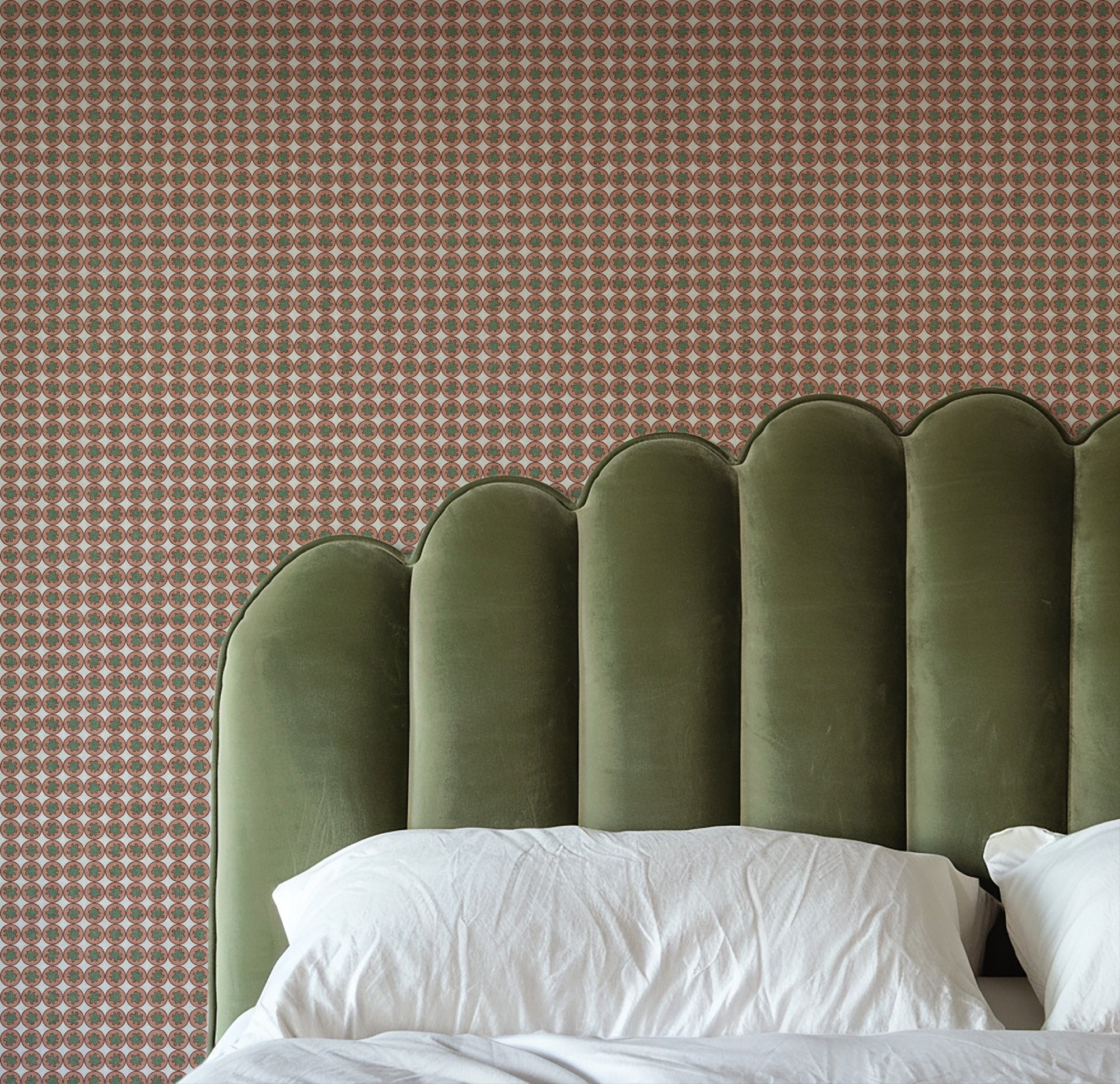 Pattern of small circles in pink and green on a gray background Small-scale geometric wallpaper pattern featuring repeating circular medallions with floral-inspired centers, creating a refined, rhythmic design with classic charm and decorative detail. Bedroom with pink wallpaper.